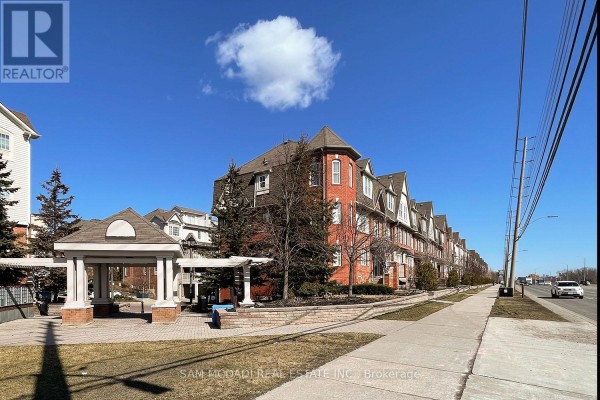 Townhouse complex with a gazebo, paved walkway, and green space. - 2 - 639 Dundas Street W, Mississauga
