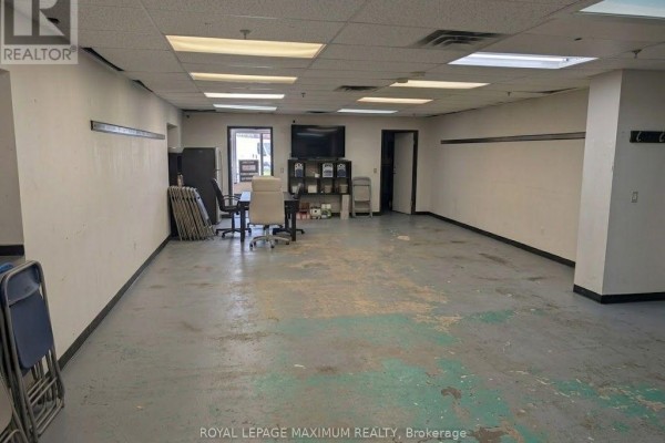 Office space with a desk, computer, office chair, and a window with blinds. - 2 - 644 Millway Avenue, Vaughan
