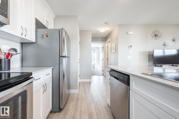 View of kitchen from another angle, featuring sink and dishwasher - #2 1203 163 St Sw, Edmonton
