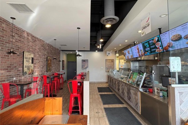 View of the service counter with menu screens and food preparation area - 2 1510 Plessis Road, Winnipeg