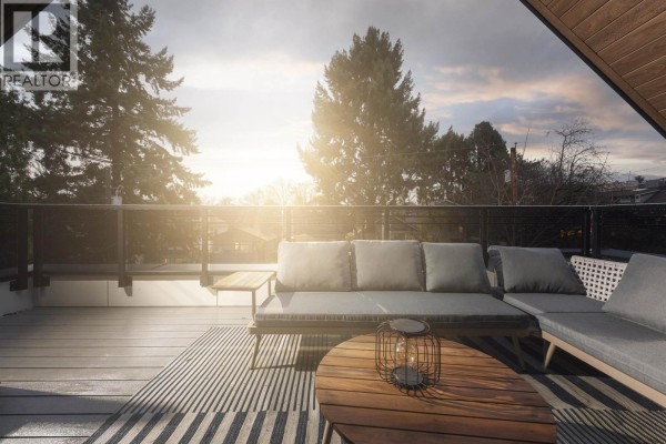 View of detached garage and landscaped yard with dining table and greenery - 2 2637 W 12th Avenue, Vancouver