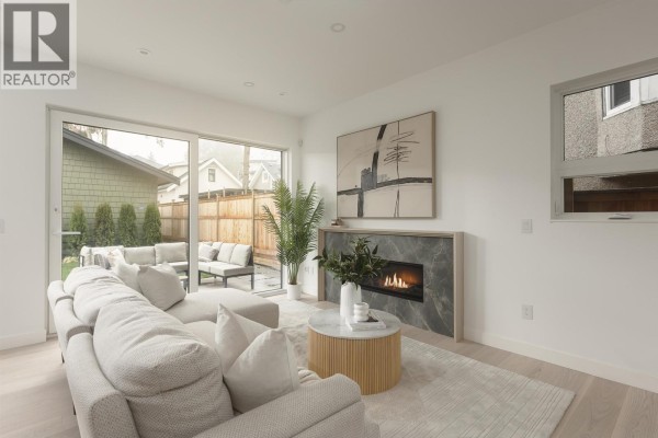 Bright living room with modern furniture, fireplace, and large windows - 2 2755 W 11th Avenue, Vancouver
