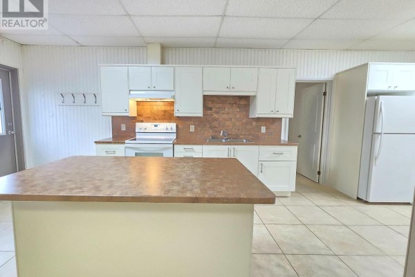 Kitchen with white cabinets, white appliances, a brown countertop island, and tiled floor. - 2-341 Queensville Side Road, East Gwillimbury