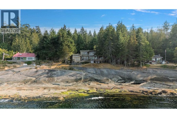 Waterfront homes on a rocky coastline with dense evergreen forest behind. - 2 37 Salamanca Road, Galiano Island