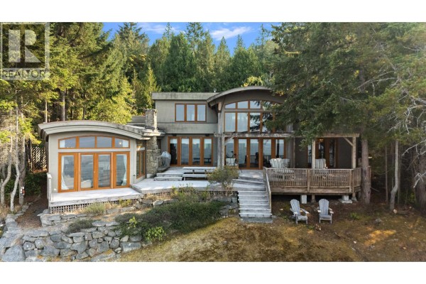 Modern multi-level home with decks, large windows, and stone accents. - 2 37 Salamanca Road, Galiano Island