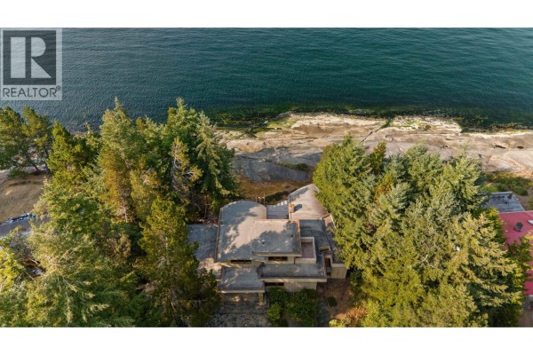 Aerial view of a multi-story house with flat roof and surrounding trees. - 2 37 Salamanca Road, Galiano Island