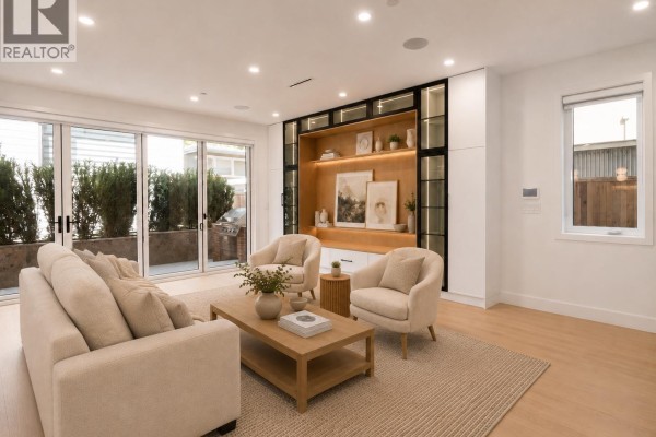 Living room with beige sectional sofa, armchairs, wooden coffee table, and built-in shelving. - 2 5963 Granville Street, Vancouver