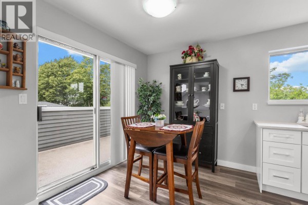 Laundry room with a white washer and dryer, a tall water heater, and a storage cabinet. - 2 6320 48a Avenue, Delta