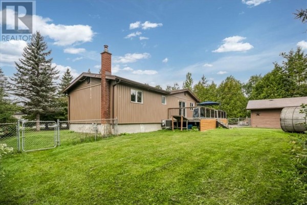 House with brick chimney, wooden deck, and shed - 2 Adam Lively