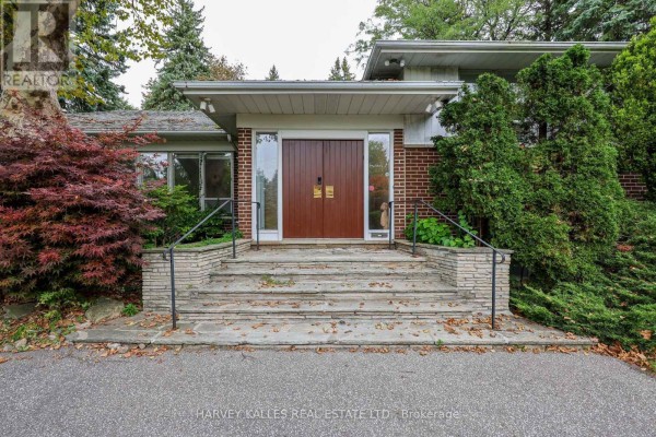 Front entrance with stone steps, double wooden doors, and glass accents. - 2 Clovestone Road, Toronto