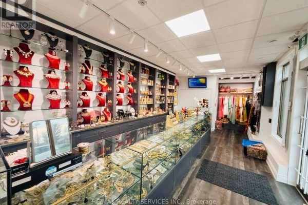 Jewelry store interior with display cases filled with jewelry and wall shelves holding merchandise. - 2 Davenfield Circle, Brampton