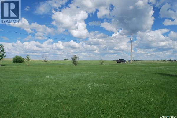 Vast grassy area with scattered trees and a vehicle in the distance - 2 Douglas Drive, Last Mountain Lake