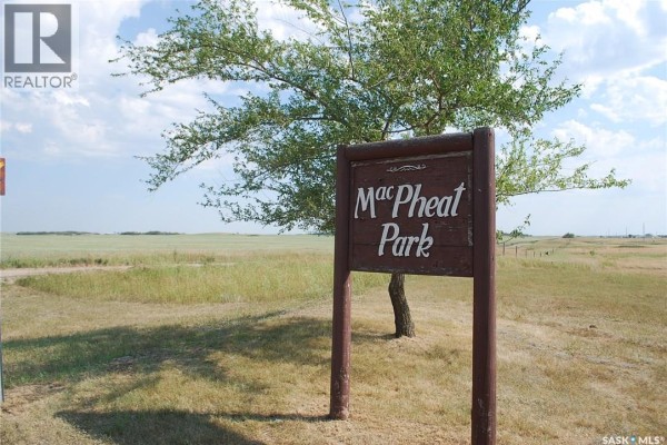 Wooden sign for MacPheat Park surrounded by open land and blue sky - 2 Douglas Drive, Last Mountain Lake