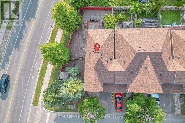Aerial view of the roofs of townhouses and backyards, with a street on the left. - 2 Gilgorm Road, Brampton