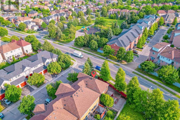 Aerial view of a suburban neighborhood showing townhouses, streets, and a park with playground. - 2 Gilgorm Road, Brampton