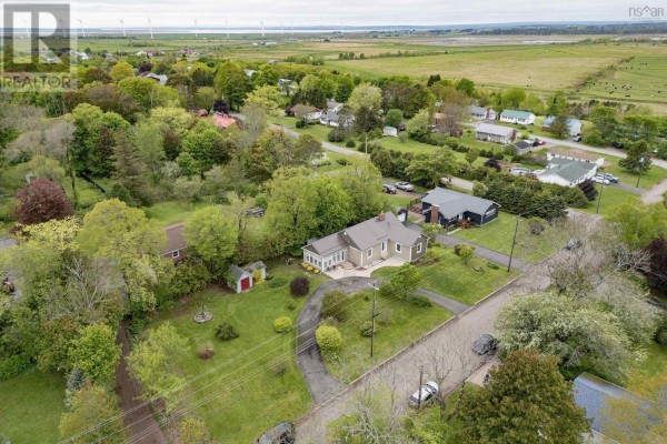 Aerial view of a single-family home on a large lot with surrounding fields and wind turbines in the distance. - 2 Lamy Street, Amherst