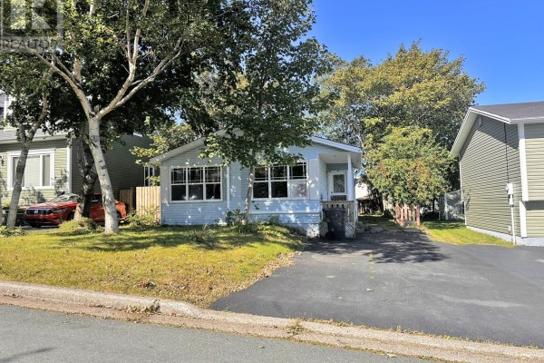Exterior view of a light blue house with surrounding trees, lawn, and neighboring houses. - 2 Mcmaster Place, Mount Pearl