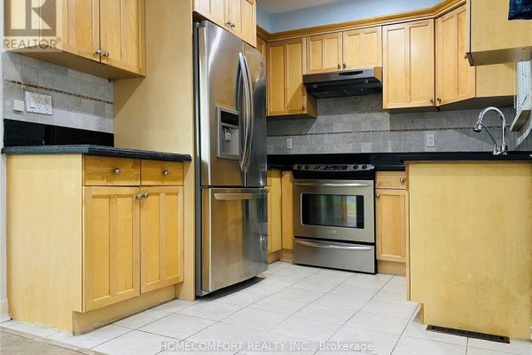 Kitchen with light wood cabinets, stainless steel appliances, and tiled backsplash. - 2 Mendip Crescent, Toronto