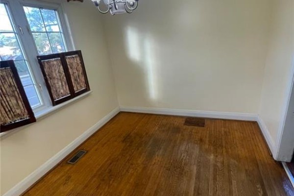 Dining area with wood floors, cream walls, and large windows with brown blinds. - 2 Menzie Avenue Unit# Upper, Guelph