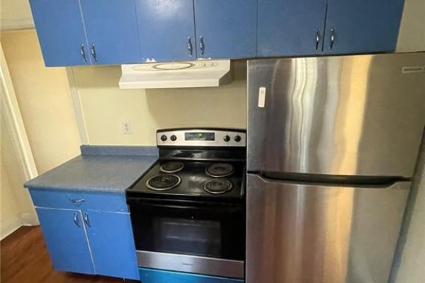 Kitchen with blue cabinets, black stove, stainless steel refrigerator, and an exhaust fan. - 2 Menzie Avenue Unit# Upper, Guelph