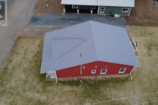 Spacious living area with modern fireplace, dining space, and open kitchen layout - 2 Michaela Street, Pictou