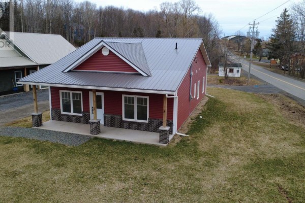 Compact laundry area with gray countertop and light wood cabinetry - 2 Michaela Street, Pictou