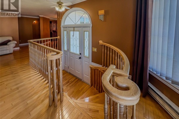 View of the foyer with a double door and a curved wooden staircase with spindles. - 2 Millers Avenue, Roberts Arm