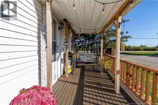 Covered wooden porch with string lights, outdoor furniture, and a barbecue grill. - 2 Orchard Crescent, Picadilly