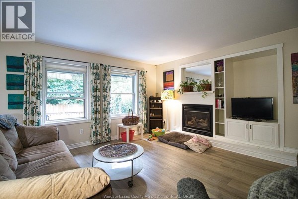 Interior foyer with light laminate flooring, a wooden dresser, mirror, and open doorway. - 2 Thomas Crescent, Chatham