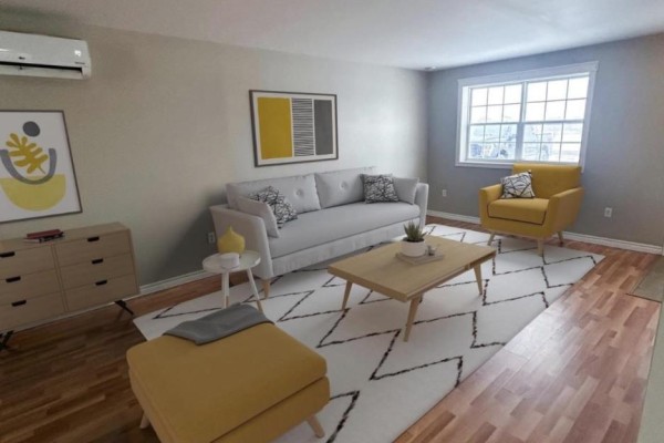 Living room with a light grey sofa, yellow armchair, and light wood coffee table. - 20-22 Sarah Court, Mermaid