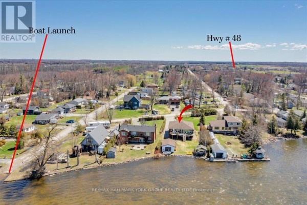 Aerial view highlighting the property boundaries, driveway, and surrounding houses on the waterfront. - 20 Burnie Road, Georgina