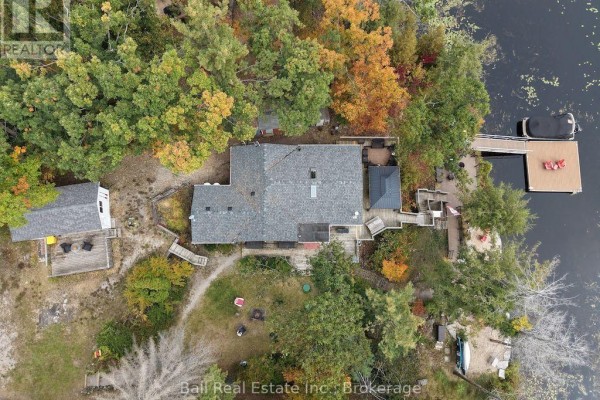 Overhead view of the property shows the rooflines of the main house, guest bunkie, and outbuildings. - 20 Fire Route 93, Trent Lakes