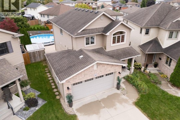 Aerial view of a detached house with a two-car garage and a manicured front lawn. - 20 Goldenrod Court, Chatham