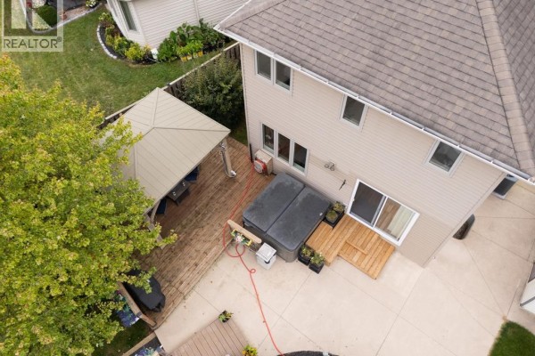 Aerial view of the backyard featuring a hot tub, wooden deck, and a gazebo. - 20 Goldenrod Court, Chatham