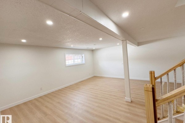 An interior view of a nail salon with pedicure chairs, manicure tables, and a reception desk. - 20 Hunt Road Nw, Edmonton