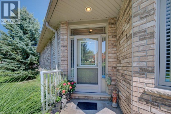 Close-up of the townhouse front door with glass panels and brick facade. - 20 Isherwood Avenue Unit# 29, Cambridge