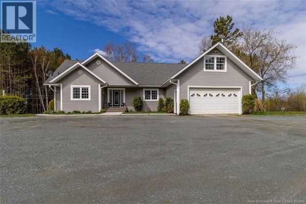 Front view of the house with a driveway, garage, and landscaped yard. - 20 Left Branch Salmon Hill Road, Florenceville Bristol