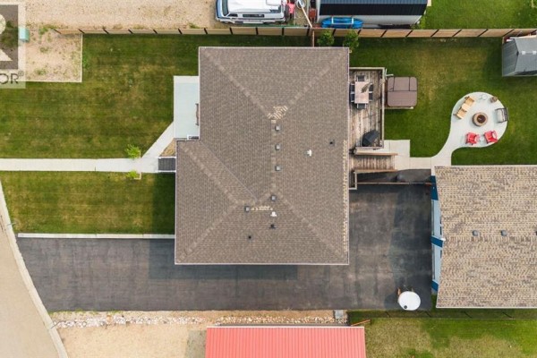 Aerial view of the residential property showing the house, garage, and surrounding landscape. - 20 Marina View, Rural Stettler No  6, County Of
