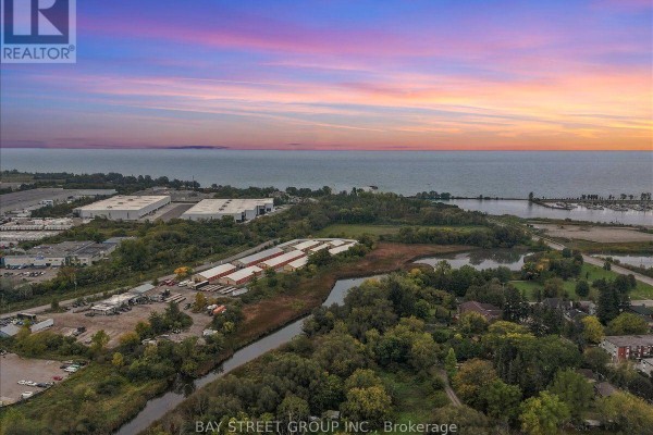 Aerial view of a suburban neighborhood with townhouses and Lake Ontario in background. - 20 Nautical Way, Whitby