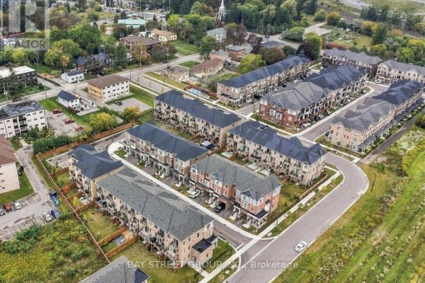 Aerial view looking down on a complex of townhouses with multiple levels. - 20 Nautical Way, Whitby
