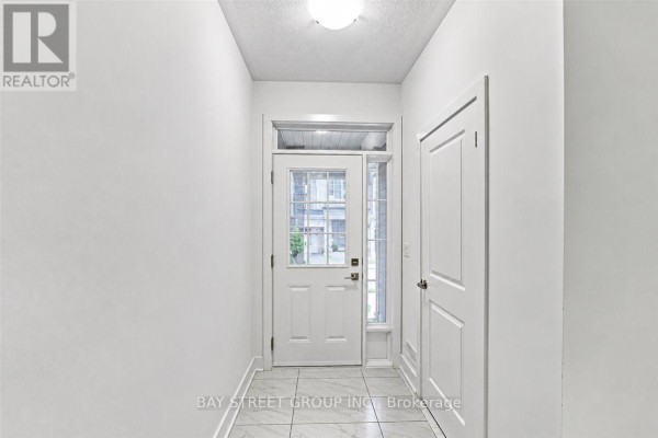 Interior entryway with white walls, white door, and marble tile flooring. - 20 Nautical Way, Whitby