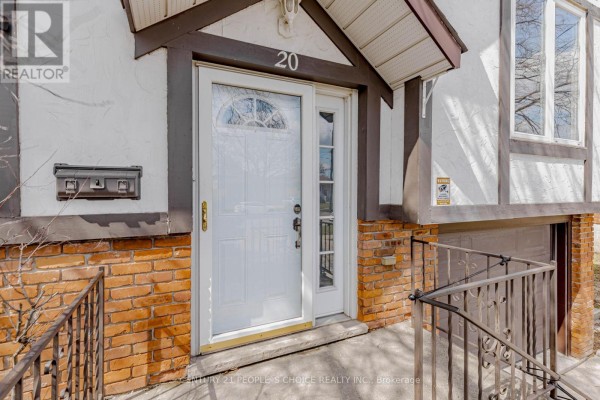 Close-up of the front door with white paint, a glass pane, and brick foundation. - 20 Normajean Avenue, Hamilton