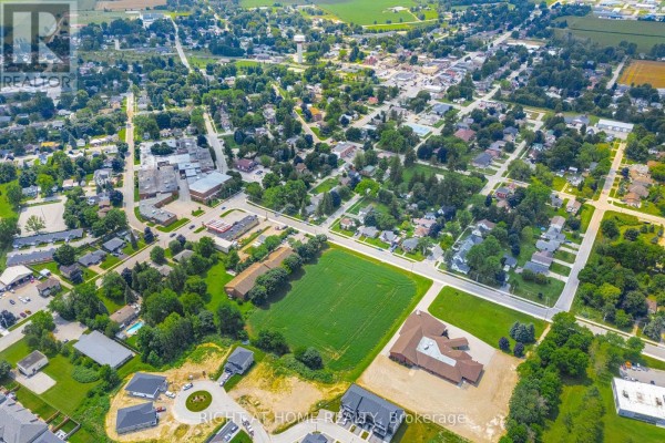 Aerial view of Minto showing houses, businesses, and a large green field from above. - 20 Part Lot Con 1, Minto
