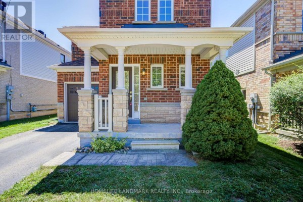 Close-up of the covered front porch of a brick house with stone accents and pillars. - 20 Richard Coulson Crescent, Whitchurch Stouffville