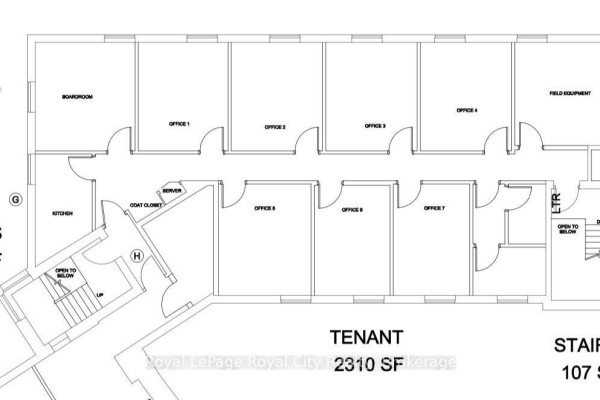 View of building exterior and parking lot with cars under a blue sky with clouds. - 200 - 15 Lewis Road, Guelph