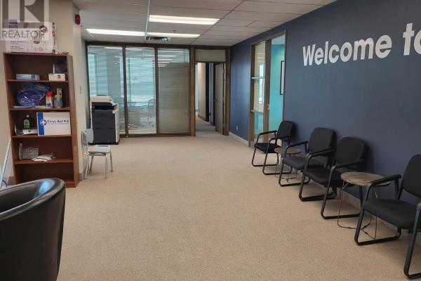 Waiting area with chairs, a bookshelf, and a blue accent wall with 'Welcome to' text. - 200 - 3100 Steeles Avenue W, Vaughan