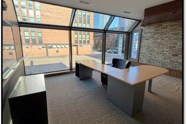 Corner office space with large windows, a desk, chair, and beige carpeting. - 200 - 484 Richmond Street, London East