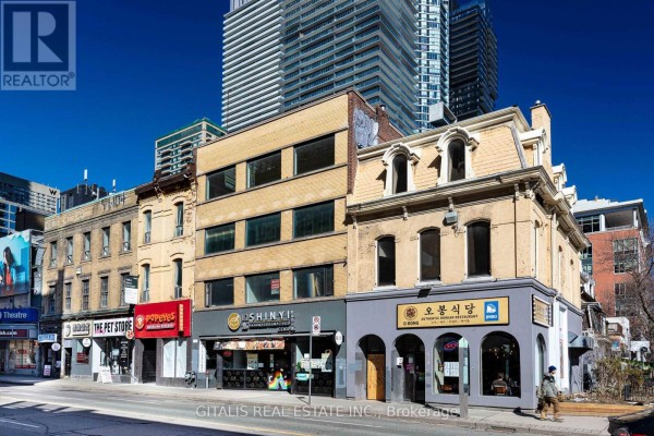 Exterior view of a commercial building with a restaurant and adjacent businesses. - 200 - 639 Yonge Street, Toronto