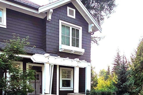 Dark brown siding townhouse with white trim, window box, and trees. - 200 1290 Mitchell Street, Coquitlam