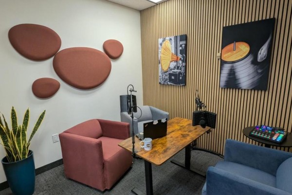 Small studio room with colorful chairs, microphones, and wood-paneled walls. - 200-17 - 350 Burnhamthorpe Road W, Mississauga